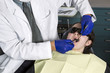 Photo: Dentist doing examination on teeth on young girl Dentist doing examination on teeth on young girl