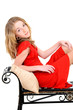 child with red dress on bench
