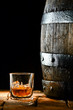 Glass of brandy alongside an oak barrel
