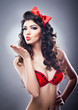  girl with a red bow on her head and red bra send a kiss