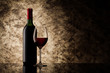 Photo: bottle with red wine and glass on a old stone bottle with red wine and glass on a old stone