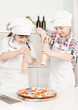 boy and girl chefs prepare pizza