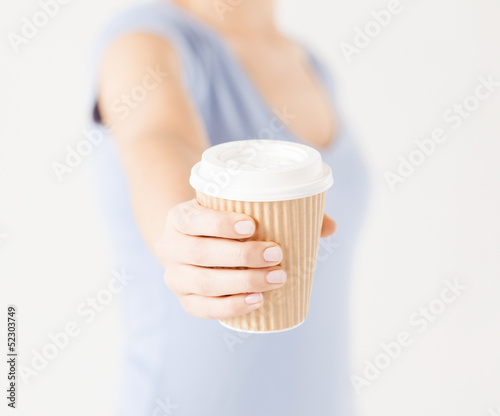 Photo: woman hand holding take away coffee cup woman hand holding take away coffee cup