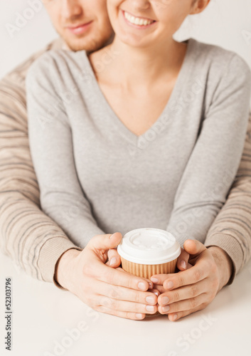 Photo: woman and man with take away coffee cup woman and man with take away coffee cup