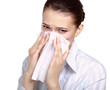 A portrait of a young woman blowing her nose