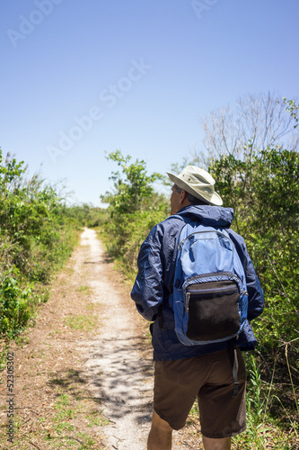 Photo: Man Hiking on a Path in a National Park Man Hiking on a Path in a National Park