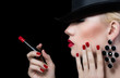 Beautiful young woman with red lips and manicure