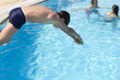 Activities on the pool. Cute boy swimming and playing in water i