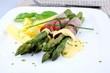 Green asparagus with ham and sauce, close up
