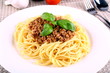 Delicious spaghetti bolognese with basil leaves