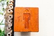 Brown hard wood polished toilet sign