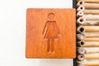 Brown hard wood polished toilet sign