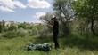 Camper pitching a tent at the mountain