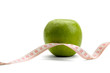 A green apple and a measuring tape isolated on white background
