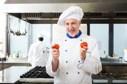 Photo: Portrait of a chef in his kitchen Portrait of a chef in his kitchen