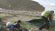 Campers pitching a tent at the mountain