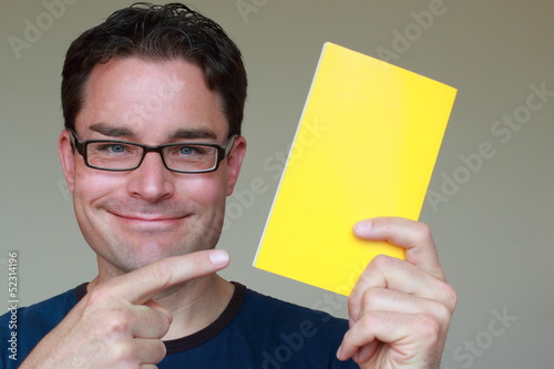 Photo: Man with glasses directing attention to an advertisement Man with glasses directing attention to an advertisement