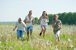 Photo: women with teens running in grass women with teens running in grass