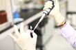 Hands are injected chemicals into the bottle.