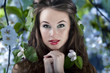 Gorgeous girl with flowers in hair, proffesional make up