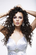 Fashionable Woman with Frizzy Hair. Earrings. Curly Hairstyle