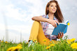 Foto: beautiful girl with book on grass beautiful girl with book on grass
