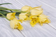 Bouquet of yellow tulips on a wooden table