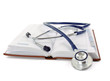 A stethoscope lying on a book, isolated on white background