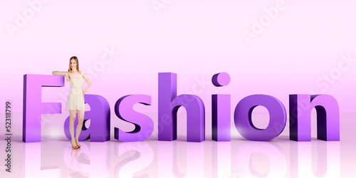 Photo: Young woman standing next to a word FASHION Young woman standing next to a word FASHION