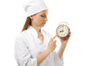 medical female doctor holding alarm clock,  isolated on white