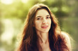 portrait of a young woman with a long beautiful hair outdoors .