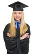 Portrait of smiling young woman in graduation gown