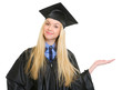 Woman in graduation gown presenting something on empty palm