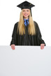 Smiling young woman in graduation gown showing blank billboard