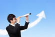 business man looks through a telescope
