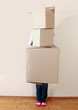 Woman holding stack of boxes