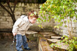 Photo: Cute boy gadening in his back yard Cute boy gadening in his back yard