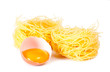 Several eggs and pasta on a white