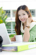 Asian women student looking and smiling on the phone