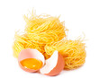 Several eggs and pasta on a white