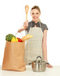 Woman in apron standing near table  with grocery bag