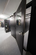 Open door in sealed corridor with telecommunication racks.