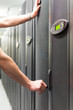Foto: Man opens telecommunication racks. Man opens telecommunication racks.