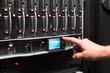 Foto: Man controls the rack with a hard drives. Man controls the rack with a hard drives.