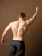 Muscular man, isolated on brown background
