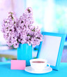 Photo: Beautiful lilac flowers on table in room Beautiful lilac flowers on table in room