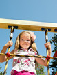 Foto: Cute little girl is climbing up on ladder in playground Cute little girl is climbing up on ladder in playground