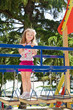 Cute little girl is climbing up on ladder in playground