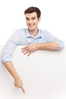 Photo: Man pointing at blank poster Man pointing at blank poster