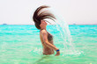 Foto: Young brunette jumping out of turquoise water of Red Sea, Egypt Young brunette jumping out of turquoise water of Red Sea, Egypt
